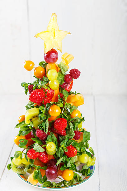 istock Creative fruit Christmas tree with different berries, fruits and 518833691