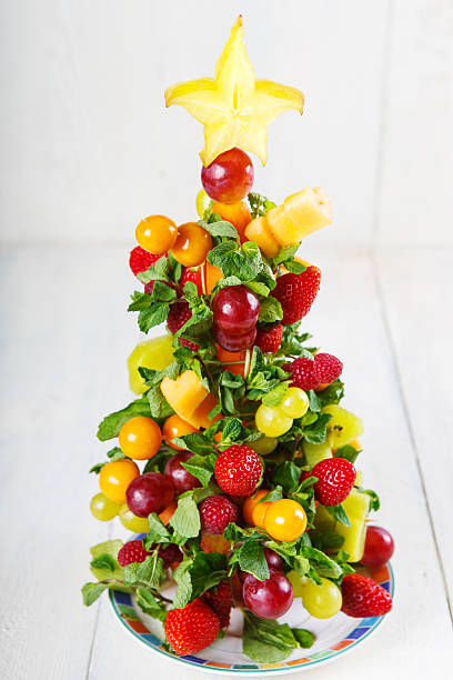 istock Creative fruit Christmas tree with different berries, fruits and 518833695
