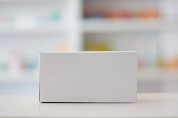 istock white blank medical packaging with pharmacy shelves background 518833940
