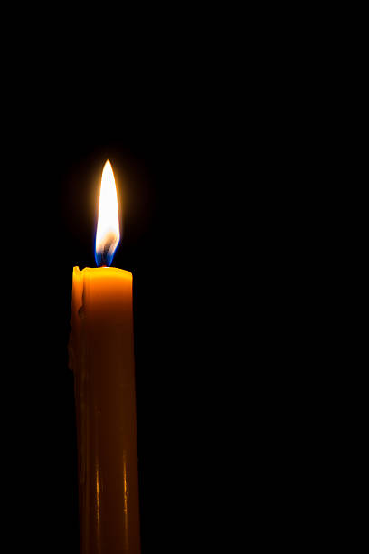 istock Yellow candle on the dark background with bokeh 518835793