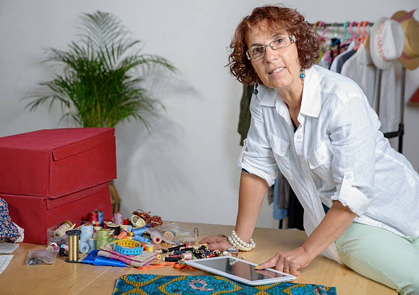 istock dressmaker look at a digital tablet in his workshop 518836881