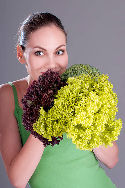 istock Woman with lettuce, cabbage and broccoli. 518838131