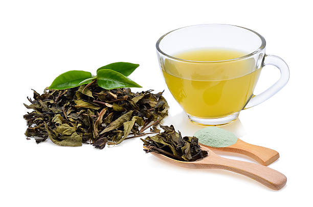 istock Glass Cup Tea with green leaves on white background 518840018