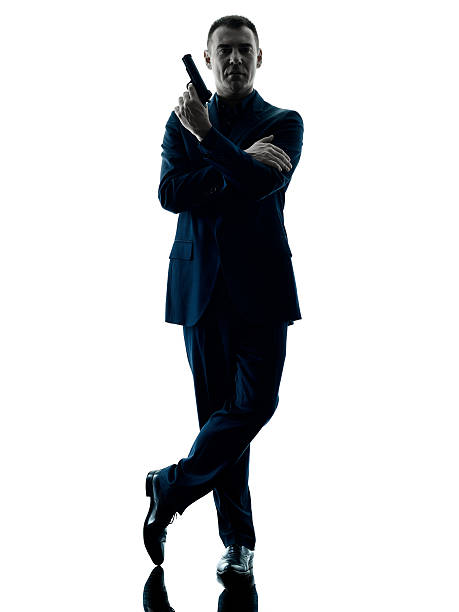 istock man with a handgun silhouette isolated 518840026