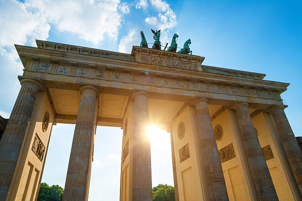 istock summer afternoon with sun backlit at Brandenburger Tor Berlin 518843550