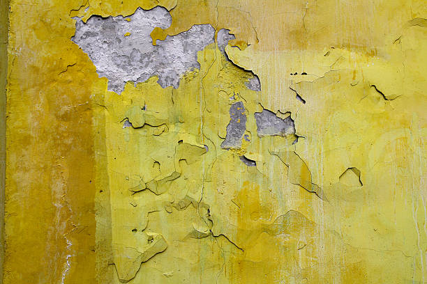 istock Old yellow paint with cracks on the wall 518844072