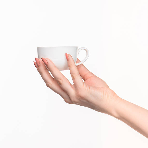 istock Woman hand with cup on white background 518844334