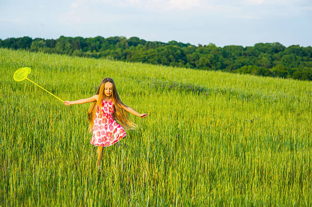 istock Little girl playing in the grass. 518844552