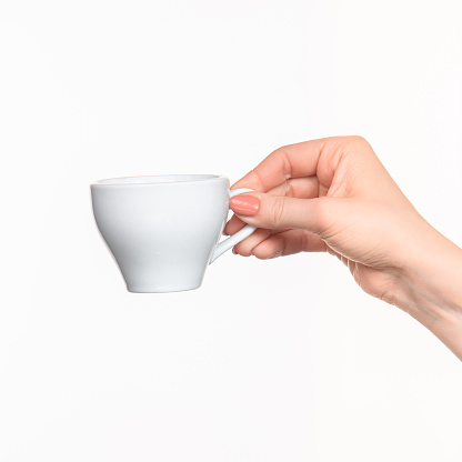 Woman hand with perfect white cup on white background 