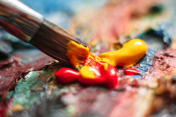 istock Painter mixes paint on the palette. Closeup 518845100