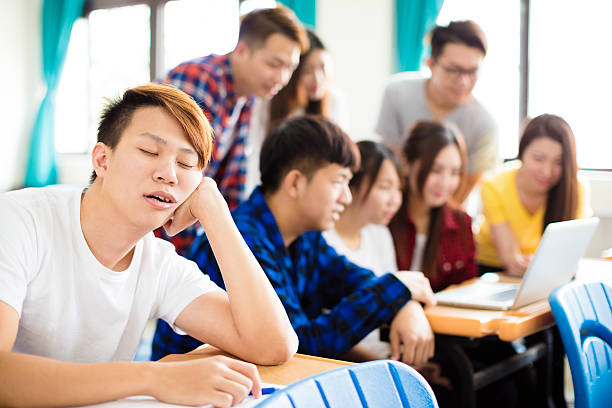 istock male Student sleeps on the desk in classroom 518846042