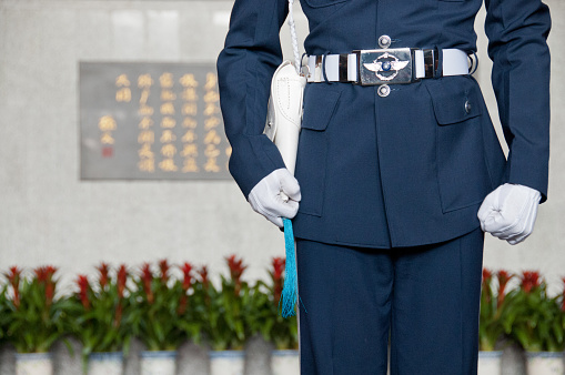 Taipei, Taiwan - February 3, 2015: Taiwanese soldier stands in front of Sun Yat Sen Memorial hall in Taiwan. The hall is built to pay respect to Dr. Sun Yat Sen, who is the founder of Taiwan country. The photo is taken in the morning during the guard changing time.