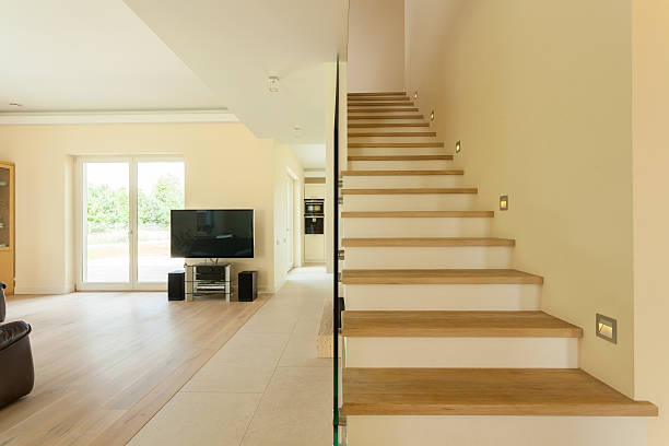 istock Spacious living room with staircase 518853961