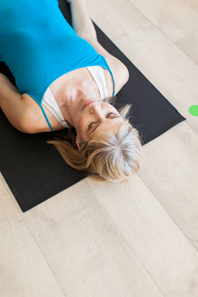 istock Beautiful woman meditating as she does yoga 518854975