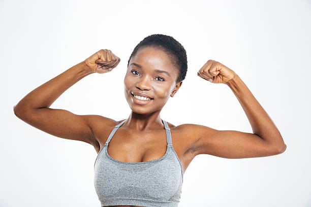 istock Smiling afro american woman showing her biceps 518857228
