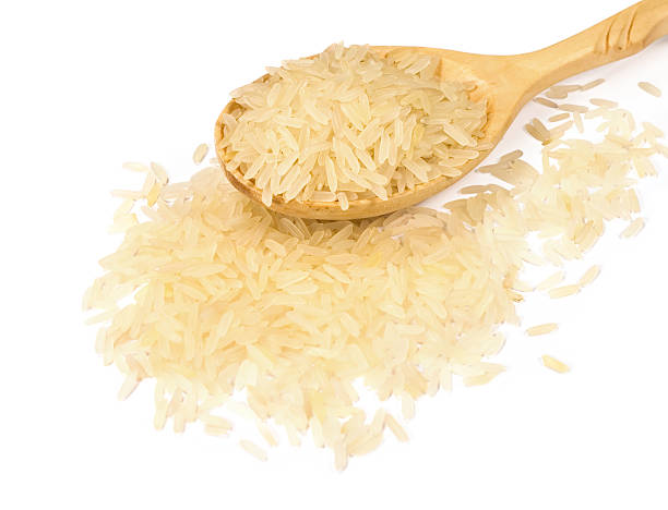istock rice in a wooden spoon 518857617