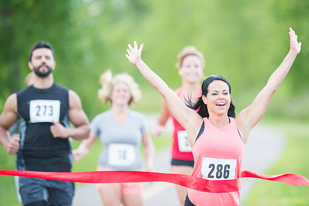 istock Woman Happily Crossing the Finish Line 518858112