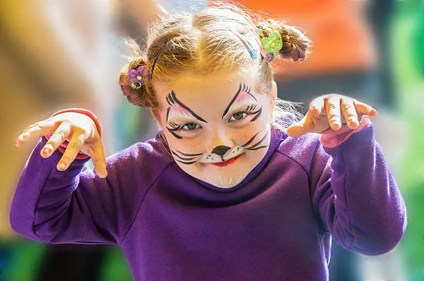 Portrait of little girl with painted face outdoors