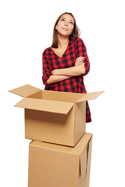 istock Young woman with cardboard boxes 518859162