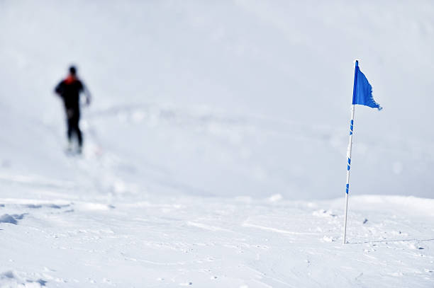 istock Blue flag on the mountain in winter 518859232