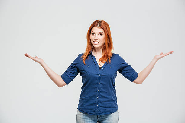 istock Beautiful smiling woman standing annd holding copyspace on both palms 518859836
