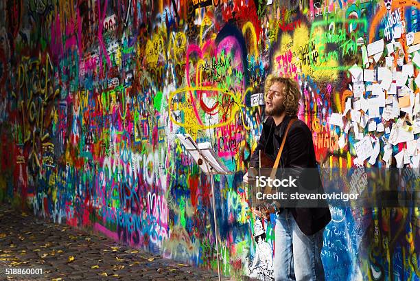 Street Busker Performing In Front Of John Lennon Graffiti Wall Stock Photo - Download Image Now