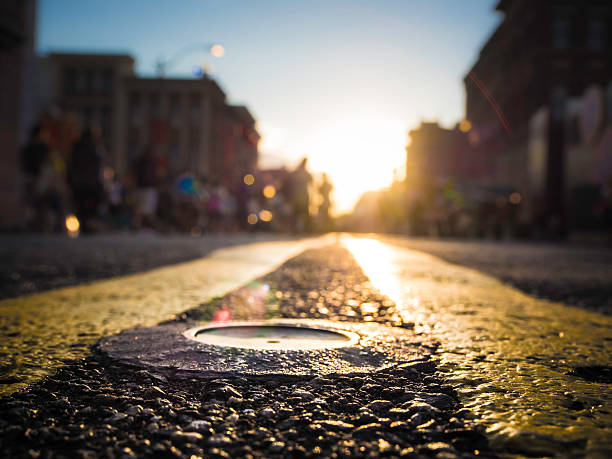 istock City street with sunset 518860375