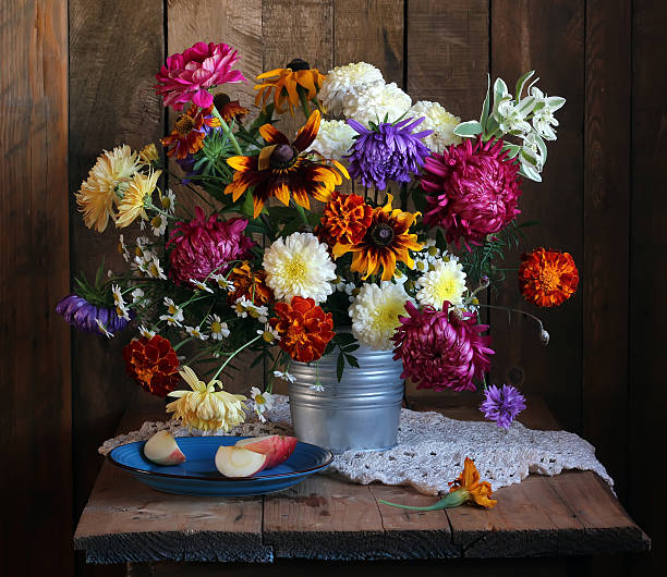 istock still life with flowers and Apple pieces on the plate. 518860704