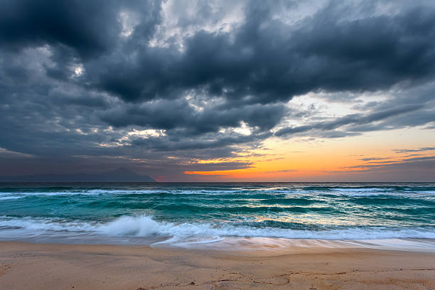 istock Sea and sandy beach with dramaric sky at sunrise 518860842