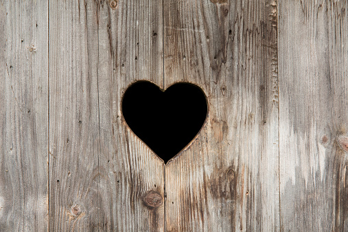 Valentine's Day background. Red heart on a wooden background.