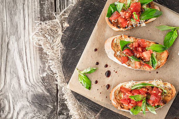 istock Bruschetta with tomatoes and basil on  wooden board top view 518866624