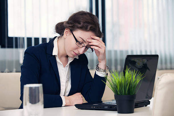 istock business woman is hurt by the head at work 518867078