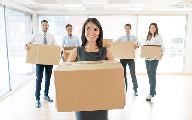 group of people moving to a new office - business looking at camera office new imagens e fotografias de stock