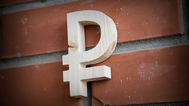 istock Wooden russian ruble symbol on a brick wall 518870232