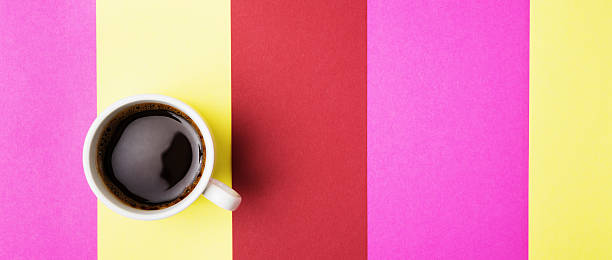 istock Cup of coffee over color strips background 518870288