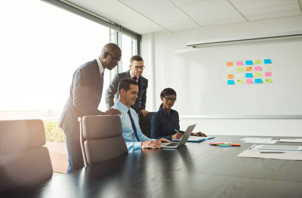istock Four of young business people in office with chart 518870574