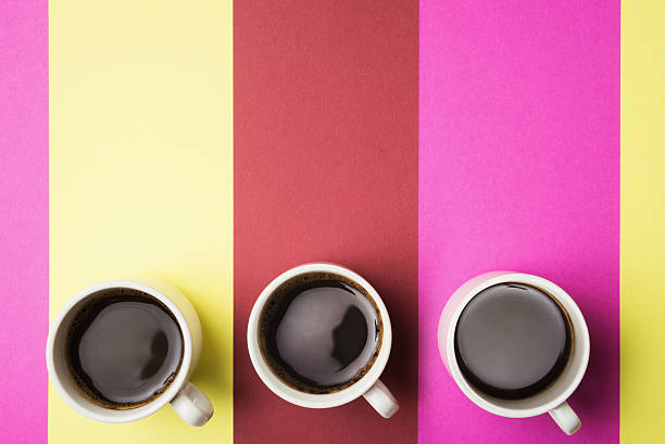 istock Three cups of coffee over multicolored strips 518870760