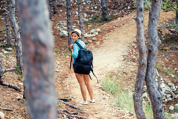 istock female with backpack trekking on mountains, walking and running 518872084