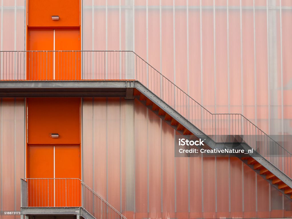 Modern Orange Fire escape stairs Fire escape stairs on the outside of a modern sports hall Abstract Stock Photo