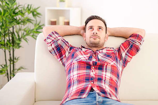 istock Pensive man relaxing at home 518873188