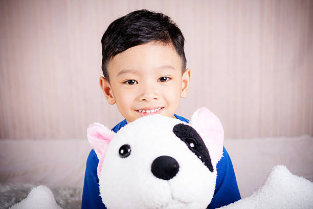 istock The boy is happy with doll dog 518873266