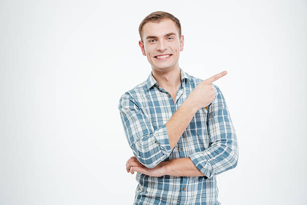 istock Smiling casual man pointing finger away 518873432