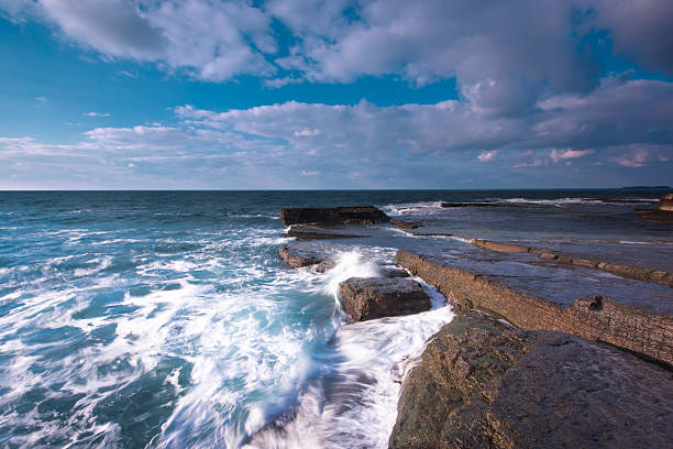 istock Long exposure shot on amazing rocks and sea 518873468