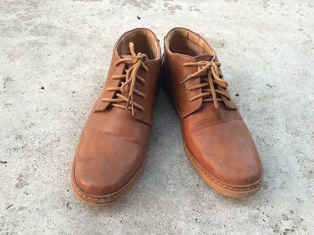 istock Brown shoes on concrete. 518873562