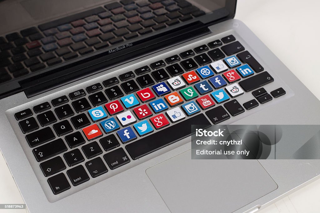 Social Media Logos on Macbook Keyboard Sakarya, Turkey - October 1, 2014: Social Network Brands Logos Placed on Computer Keyboard Auto Post Production Filter Stock Photo