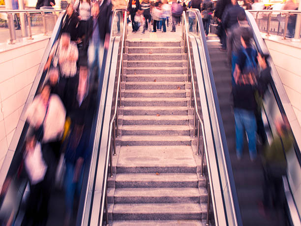 istock Long Exposure shot of people on escalators 518875013