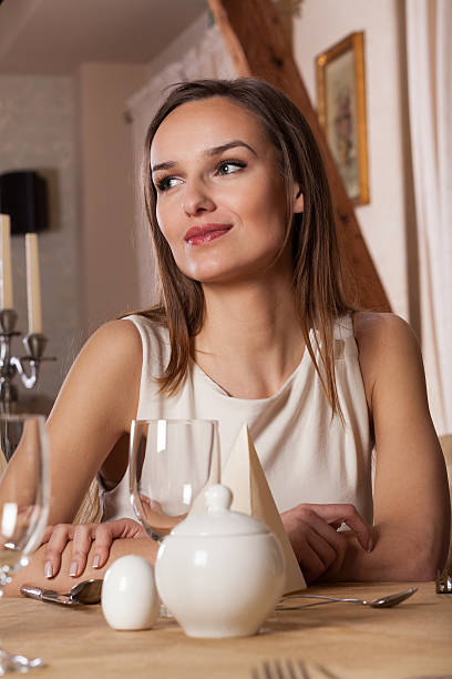 istock Young woman waiting in restaurant 518875511