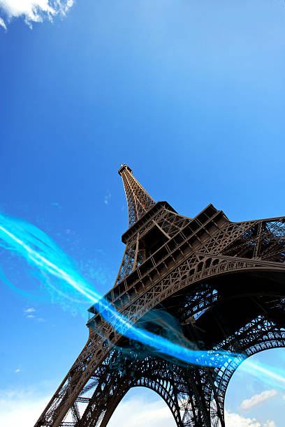 istock blue streak of lights passing under Eiffel Tower 518876049