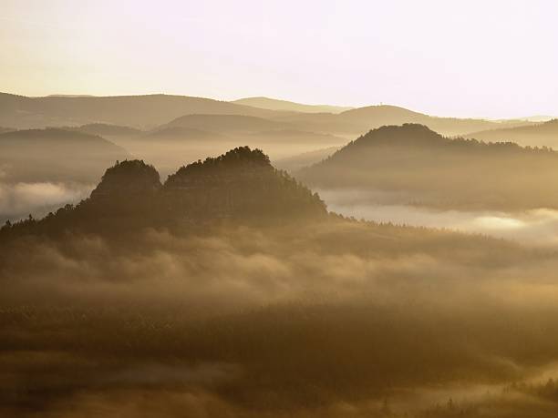 istock Mountain cut lighting mist. Deep valley is full of fog 518876833