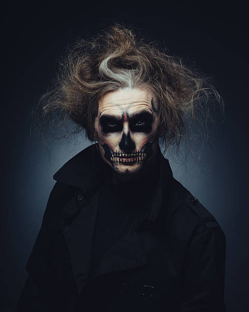 istock Portrait of man with Halloween skull makeup 518877331